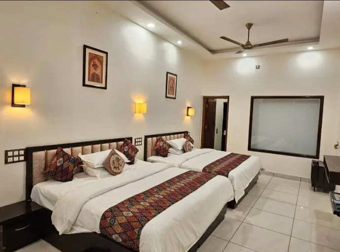 “Large 4-bed AC room with TV & Wi-Fi at Nandakam Rest House. Ideal for groups or large families visiting Tirumala.”
